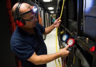 TotalEnergies’s HPC (high performance computer): an operator inspects the cooling distribution unit